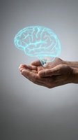Glowing cyan brain hologram floating above cupped hands representing mental health, artificial intelligence, neuroscience and cognitive technology concepts.