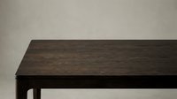 Dark wooden table with minimalist design against neutral background, suitable for interior design, furniture catalogs, and home decor projects.