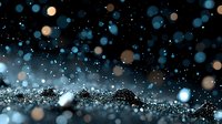 Magical glowing blue and gold bokeh lights scattered on dark background with glitter particles creating dreamy atmospheric effect.