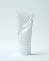 White minimalist cosmetic tube with elegant curved design on clean background, suitable for skincare and beauty product packaging mockup.