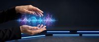 Young professional with light skin tone holding glowing blue digital sound waves and data visualization between hands, representing audio technology, music production, and digital innovation for tech and business applications.