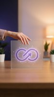 Hand touching transparent glass panel displaying glowing purple infinity symbol with magical particles on wooden desk in modern office setting with warm lighting and potted plants.