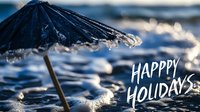 Festive beach umbrella with water droplets and bokeh lights against ocean waves, white holiday greeting text overlay. Seasonal greeting card design.