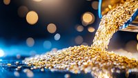Golden grain pouring from scoop onto pile with bokeh lights, representing harvest, agriculture, cereal production, and food industry concepts for commercial use.