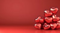 Red metallic heart-shaped balloons clustered together on vibrant red background for Valentine's Day celebration, romance and love themed designs.
