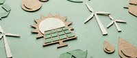 Eco-friendly renewable energy icons crafted from cardboard and paper on green background, featuring solar panels, wind turbines, and recycling symbols.