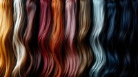 Colorful hair extensions collection displaying vibrant wavy strands in rainbow spectrum from blonde to black for beauty salon styling and fashion design.