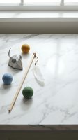 Minimalist wellness spa accessories with facial roller, gua sha tool and massage balls on marble surface for skincare routine and self-care rituals.