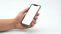 Hand holding modern smartphone with blank white screen mockup for app presentation and mobile interface design projects.