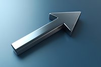 Metallic silver arrow pointing upward on blue gradient background, representing growth, direction, and progress in business and technology applications.