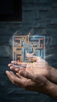 Hands holding glowing neon maze puzzle with orange and blue light trails, symbolizing problem-solving, innovation, and digital technology solutions for business concepts.