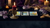 Mystical tarot card reading setup with burning candles, amethyst crystals and spiritual divination tools on dark surface for fortune telling sessions.