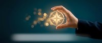 Businessman holding a glowing compass rose symbol, representing leadership, navigation, and strategic direction in business and career growth.
