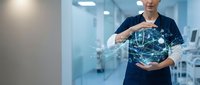Healthcare professional holding digital globe with network connections representing global medical technology and telemedicine innovation in modern hospital.