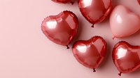 Red heart-shaped foil balloons on pink background, romantic festive decoration for Valentine's Day, wedding, or anniversary celebration. Suitable for greeting cards.