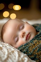 Peaceful sleeping baby close-up with soft bokeh lights, wrapped in knitted blanket. Gentle facial features captured in dreamy atmosphere with warm golden glow.