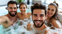 Group of diverse young friends enjoying relaxation time in hot tub spa with bubbles, smiling and having fun during wellness weekend getaway.