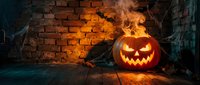 Glowing jack-o-lantern with flames against brick wall in dark cellar setting, perfect for seasonal marketing and holiday promotional materials.