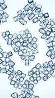 Scattered ice cubes with water droplets on white background, overhead view for beverage, food and drink styling projects.