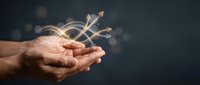 Male hands holding glowing upward arrows symbolizing growth, success, and financial progress for business and investment concepts.