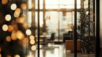 Cozy cafe interior with blurred Christmas lights and decorated tree seen through glass window, creating warm bokeh effect and festive holiday atmosphere.