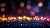 Magical glowing bokeh lights on dark background with sparkles and glitter. Festive blurred circles in pink, purple, orange and blue create dreamy atmosphere.