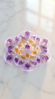 Amethyst and citrine gemstone flower arrangement on marble surface with natural lighting for luxury jewelry and crystal healing concepts.