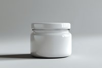 White cosmetic jar with screw cap on neutral background, minimalist product photography for skincare and beauty packaging mockup presentation.