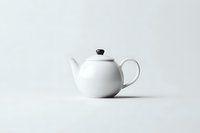 Classic white ceramic teapot with round shape and black lid knob isolated on light background. Clean minimalist composition for food and beverage marketing.