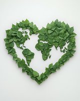 Green leaves arranged in heart shape forming world map silhouette on white background, eco-friendly concept for environmental design and sustainability projects.