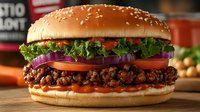 Gourmet beef burger with sesame seed bun, crispy ground meat patty, melted cheese, fresh lettuce, ripe tomato slices, and purple onion on wooden surface. Perfect for restaurant menus, food blogs, and culinary marketing materials.