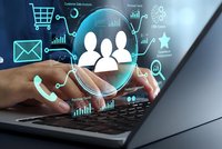 Business professional using laptop with digital customer relationship management icons and data analytics visualization for modern marketing strategy.