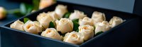 Elegant cream roses arranged in luxury black gift box for special occasions, romantic gestures, and premium floral presentations.