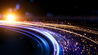 Glowing curved light trails with blue and orange streaks against dark background, dynamic motion effect with sparkles and bokeh elements creates futuristic atmosphere.
