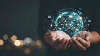 Hands holding glowing digital brain network with connected nodes and data points representing artificial intelligence and neural connections in technology.