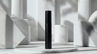 Minimalist black cylinder stands among white geometric shapes casting dramatic shadows in modern abstract composition. Clean architectural forms create depth.