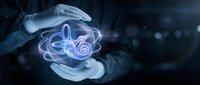 Gloved hands holding a glowing holographic human ear anatomy model in dark background, symbolizing medical innovation and hearing healthcare.