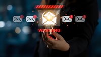 Cybersecurity warning concept with hand selecting email envelope showing security alert notification on digital interface with bokeh background.