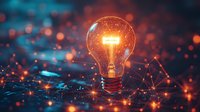 Glowing light bulb on digital network background with orange and blue bokeh particles, symbolizing innovation and creative technology solutions.