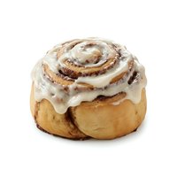 Freshly baked cinnamon roll with white cream cheese frosting, isolated on white background. Perfect for bakery, food, and dessert design projects.