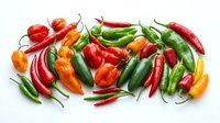 Fresh assorted chili and bell peppers in red, green, yellow and orange varieties arranged on white background for cooking, recipe and food design projects.