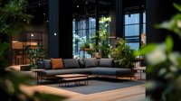 Modern dark interior with gray sectional sofa surrounded by lush green plants creating biophilic design in spacious living area with natural light from large windows.