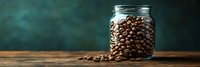 Fresh roasted coffee beans spilling from glass mason jar on rustic wooden table against dark green background, panoramic food composition with copy space.