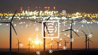 Wind turbines at sunset with digital network overlay representing smart grid technology and renewable energy connectivity.