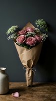 Elegant pink roses bouquet wrapped in brown kraft paper with white baby's breath flowers on rustic wooden table against dark background for gifting occasions.