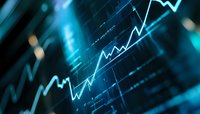 Glowing blue stock market chart showing upward trend on digital display with shallow depth of field, representing financial growth and investment success.