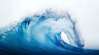 Powerful ocean wave curling with white foam spray against cloudy sky, intense blue water forming dramatic barrel shape in stormy weather conditions.