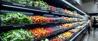 Fresh organic produce display in modern supermarket with colorful fruits and vegetables on refrigerated shelves for healthy shopping and nutrition.