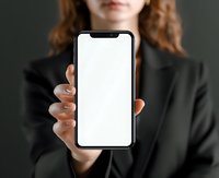 Young woman in black business suit holding smartphone with blank white screen for app or website mockup presentation.