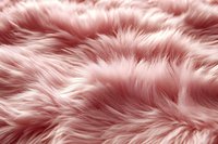 Luxurious pink faux fur texture with soft wavy pattern creates cozy background for fashion, beauty and interior design projects. Trendy dusty rose color.